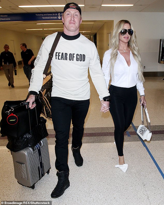 Uh oh: Kim Zolciak's husband Kroy Biermann had barricaded himself in their bedroom during an ugly argument that led to her calling the police;  they are pictured in March 2018