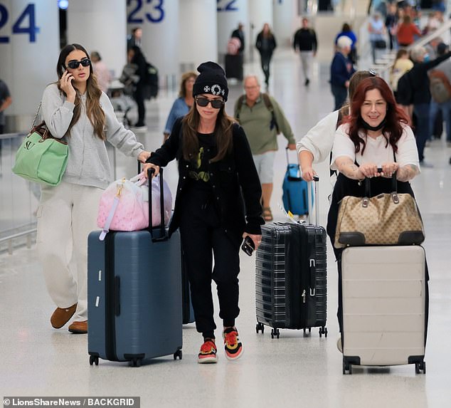 At home: Kyle Richards was spotted arriving at Los Angeles International Airport on Sunday with daughter Sophia Umansky (L) and Wilson Philips singer Carnie Wilson (R) in tow