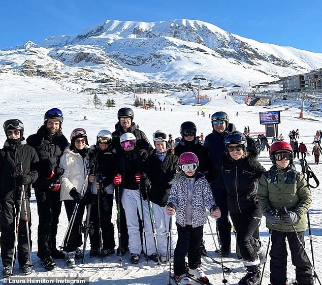 Happy days: Hamilton (second from right) reunited with ex-husband Alex Goward (fifth from left) for a luxury ski holiday with their children (Hamilton's left and right), in December - almost 12 months after they confirmed their divorce