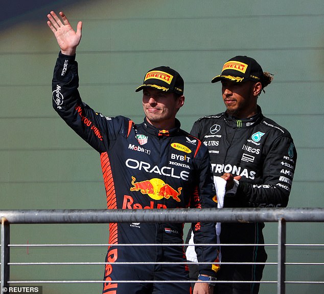 Red Bull's Max Verstappen celebrates on the podium after winning the United States Grand Prix.  He is pictured with Hamilton, who was later disqualified from his second-place finish