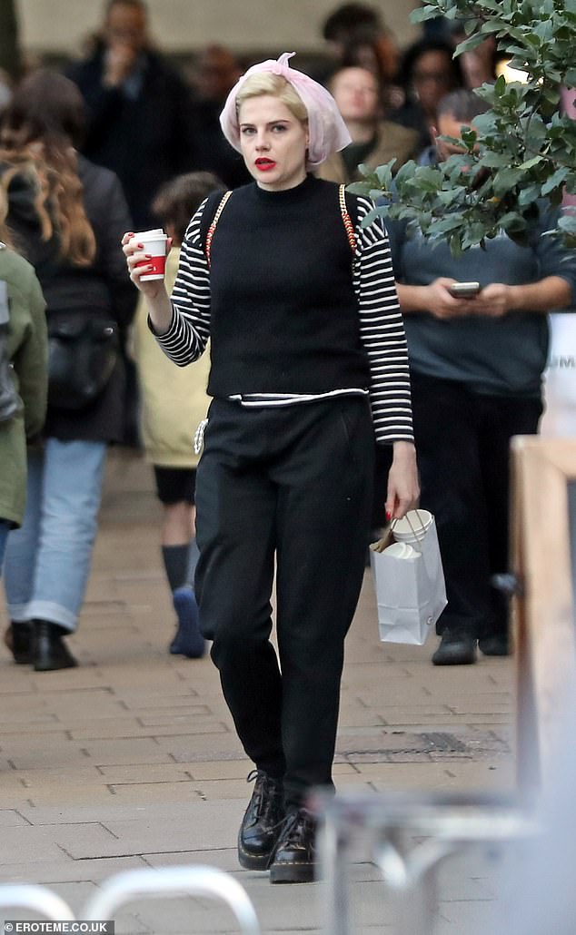 Casual: the TV star opted for a relaxed look and wore a black sweater with striped sleeves that she paired with dark trousers