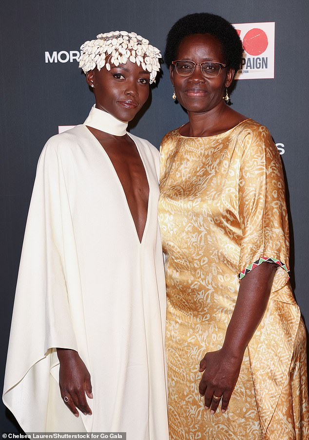 Family affair: She paired the sophisticated look with a headpiece made of white seashells and posed next to her glamorous mother, Dorothy Nyong'o, who shimmered in gold couture