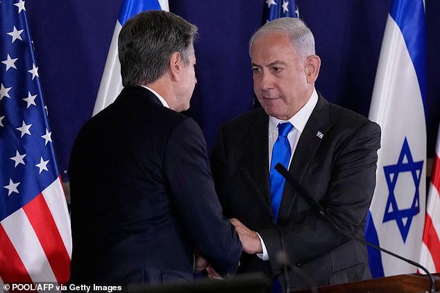 Israeli Prime Minister Benjamin Netanyahu (right) shakes hands with US Secretary of State Antony Blinken (left) during statements to the media inside The Kirya, which houses the Israeli Ministry of Defense, after their meeting in Tel Aviv on October 12