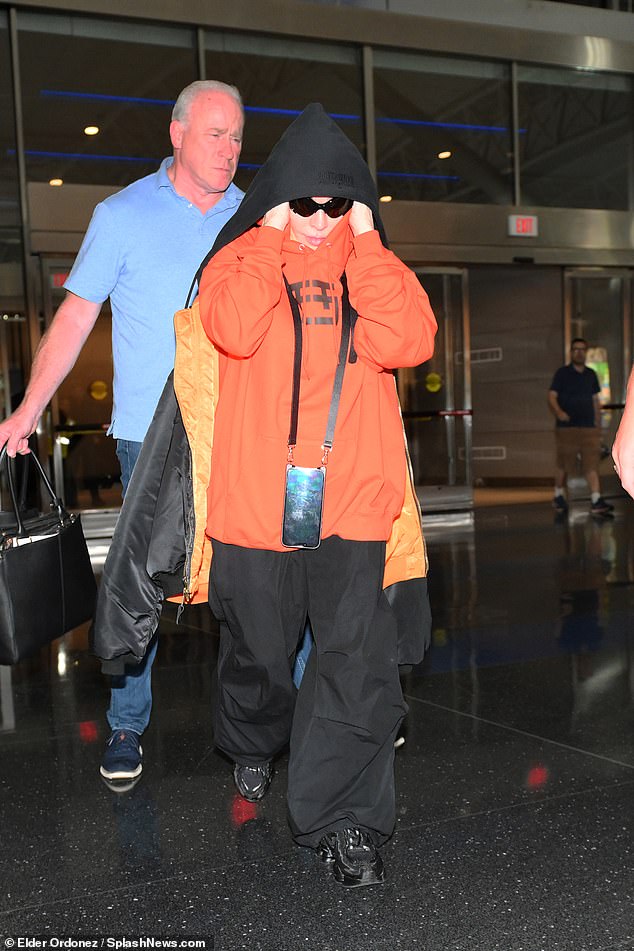 Snack time!  Madonna arrived at New York's JFK Airport on Tuesday, bodyguard in tow, to catch a flight to England, just 10 days before she was set to kick off her 78-date Celebration Tour with a sold-out concert at London's O2 Arena