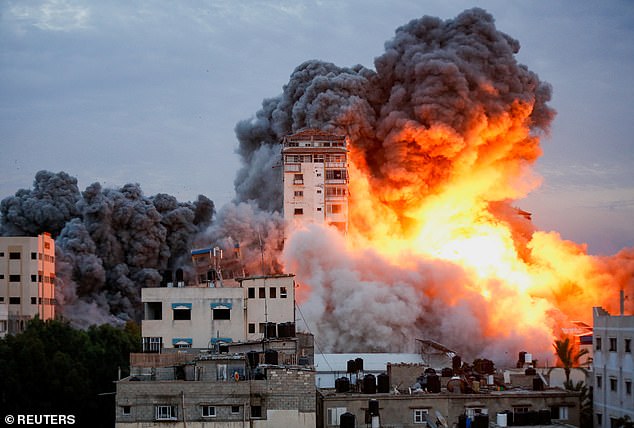 War: Smoke and flames billow after Israeli forces hit a tower block in Gaza City on October 7