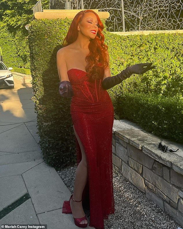 Sexy costume: Mariah Carey looked stunning in newly shared Instagram photos of herself dressed as Jessica Rabbit.  On the eve of Halloween, the 54-year-old singer put on a glamorous show in a low-cut, figure-hugging evening dress with a corset bodice and a sexy thigh-high slit