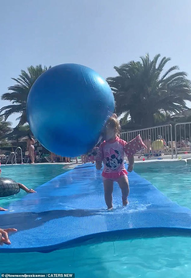 This is the hilarious moment adorable Alice Townsend, from Hull, was hit with a huge beach ball while having fun in a pool with her family.