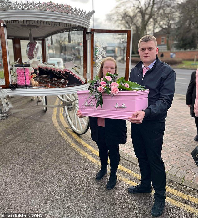 Amy Walters and her partner, Jordon Quilt, hold baby Heidi's casket during her funeral