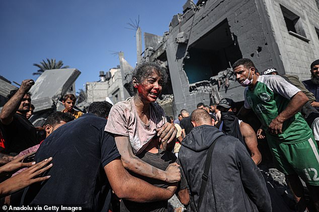 A victim covered in blood is seen after being pulled from the rubble in the town of Khan Yunis, Gaza, where some buildings collapsed or were heavily damaged during Israeli airstrikes on October 26, 2023