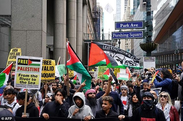 Protesters in New York waved Palestinian flags during the peaceful march from Times Square to near both the Israeli consulate and the United Nations headquarters, where the Security Council was due to meet on the weekend's violence