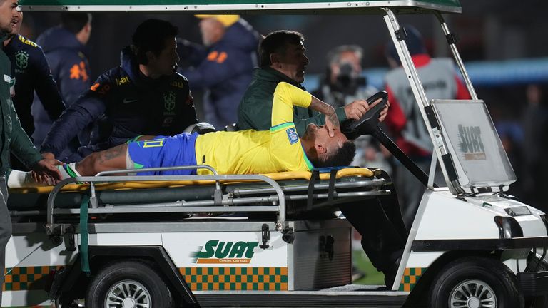 Brazil's Neymar is carried off the pitch on a stretcher after being injured during a 2026 World Cup qualifying match against Uruguay at the Centenario Stadium in Montevideo, Uruguay, Tuesday, October 17, 2023. (AP Photo/Matilde Campodonico)