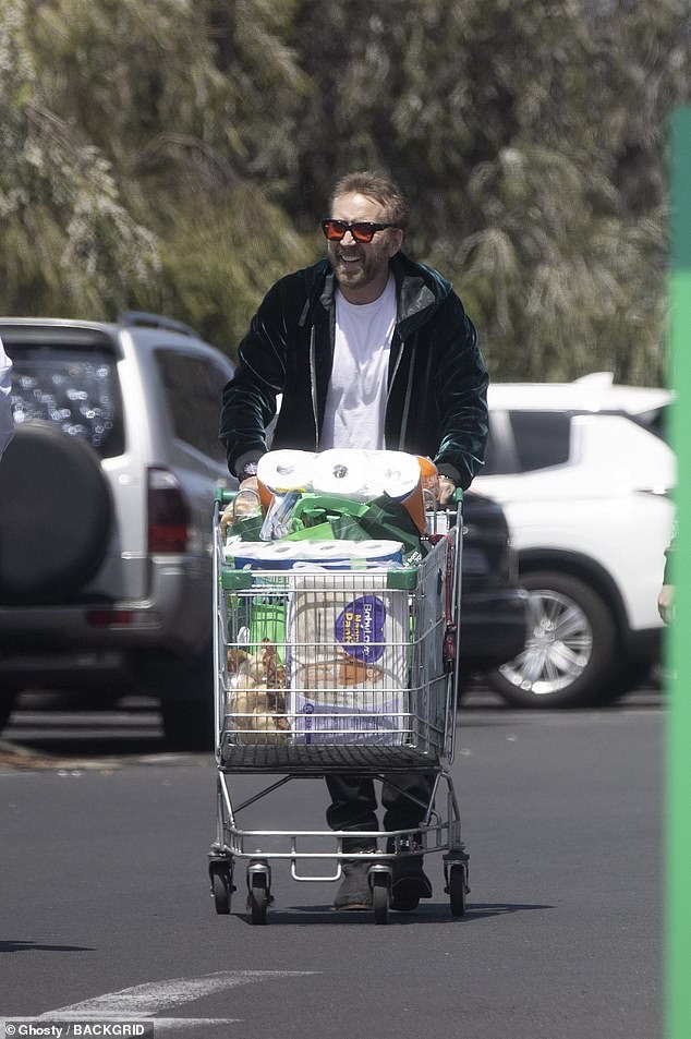 Nicolas Cage dons cowboy boots as he pushes a trolley full of groceries as he leaves a supermarket in Western Australia on Monday with wife Rico Shibata - in scenes similar to his cult film Leaving Las Vegas