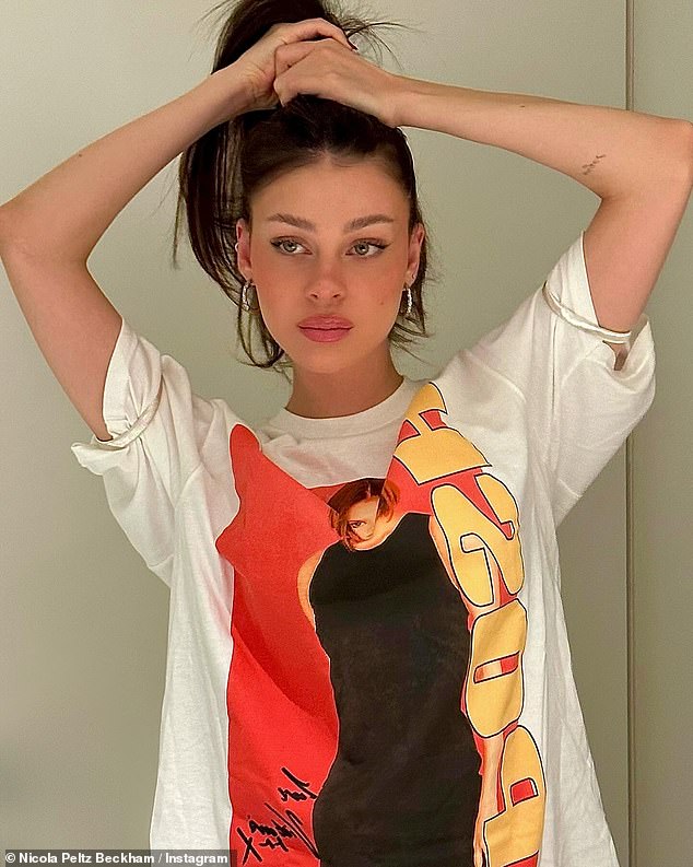 Wow: Nicola Peltz, 28, paid a sweet tribute to her mother-in-law Victoria Beckham on Friday while wearing a Posh Spice Girls T-shirt in her latest Instagram photos