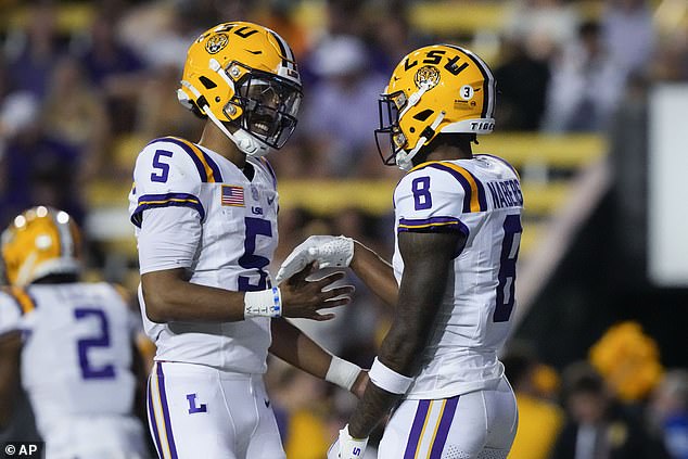 She watched as Jayden Daniels (left) threw three touchdown passes and rushed for another to help the Tigers roll over the Black Knights