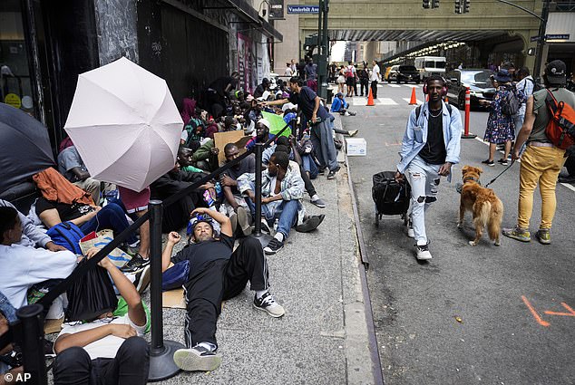 The surge in arrivals has prompted New York to say it's full, prompting migrants to go elsewhere.  This file photo shows people waiting outside the Roosevelt Hotel for beds