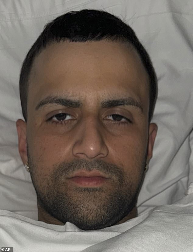 Johnluis Sanchez, 30, is guarded in his hospital bed before being charged with murder