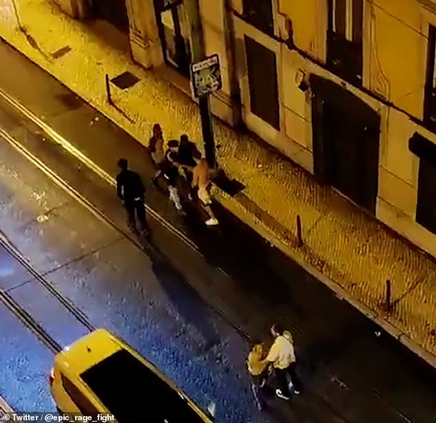 The group, who police say are British tourists, are seen in an altercation on a Lisbon street at around 4.30am on Saturday.  Daniel is pictured in a black top and white pants