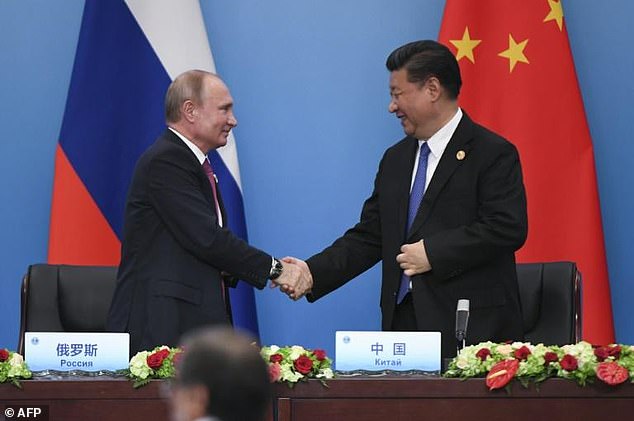 Chinese President Xi Jinping (photo right) shakes hands with Russian President Vladimir Putin in 2018 – they try to further deepen cooperation "no limits" partnership between their two countries