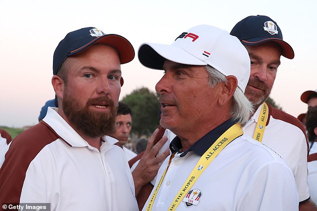 Shane Lowry and Fred Couples talk on the 18th green during Saturday's Ryder Cup