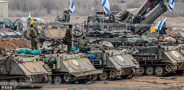 Israeli soldiers prepare for ground maneuvers at a secret location near the Gaza border