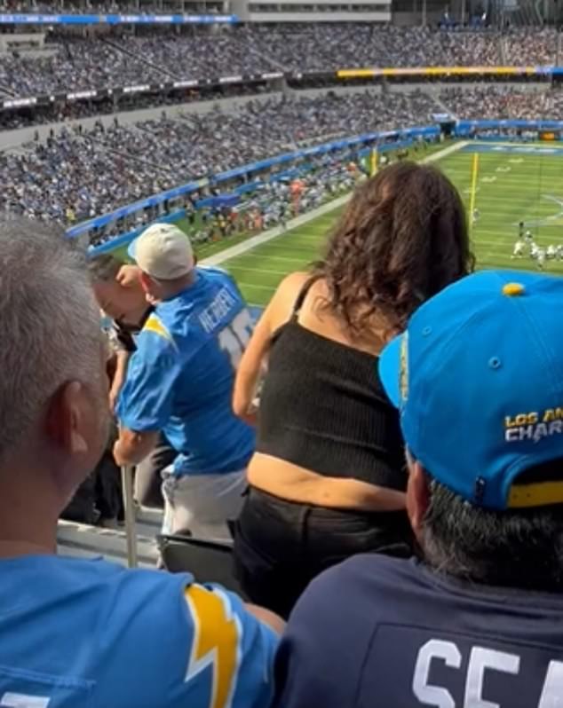 A Raiders fan was punched and thrown down a flight of stairs by a Chargers rival on Sunday