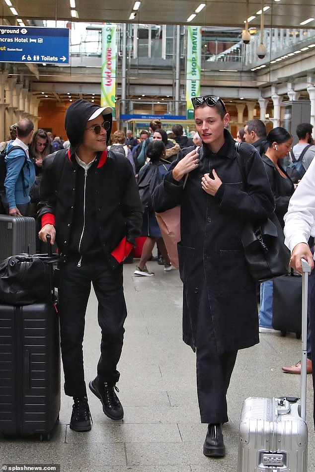 Home time: Rami Malek and Emma Corrin tried to keep a low profile as they returned to London on Wednesday after their trip to Paris for Fashion Week