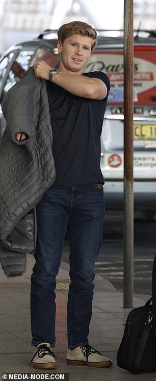 Robert Irwin, 19, couldn't wipe the smile off his face as he arrived at Sydney Airport with his girlfriend Rorie Buckey on Wednesday