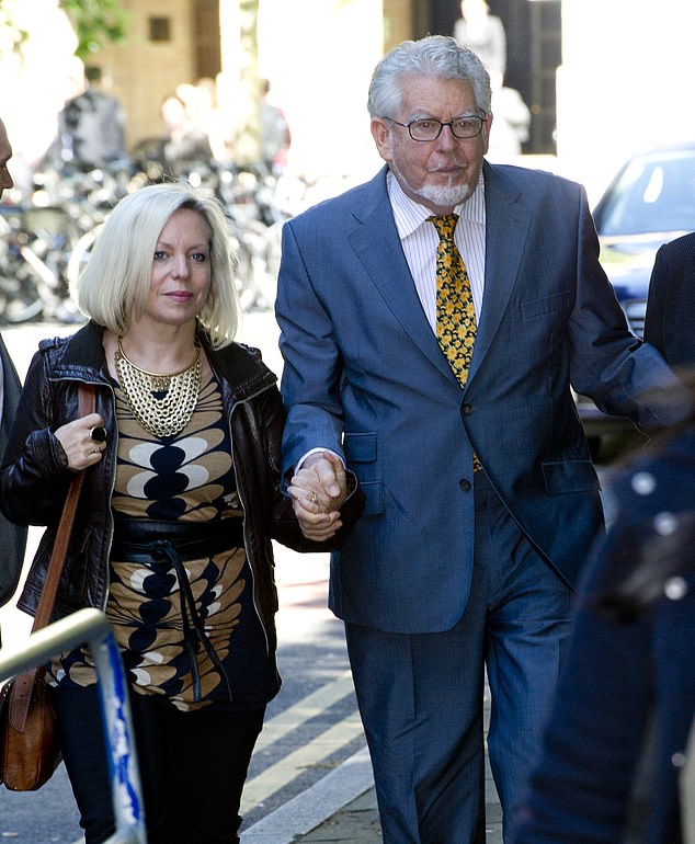 Rolf Harris' daughter has changed her name in an attempt to cut ties with the disgraced entertainer's toxic legacy (pictured together in 2014)