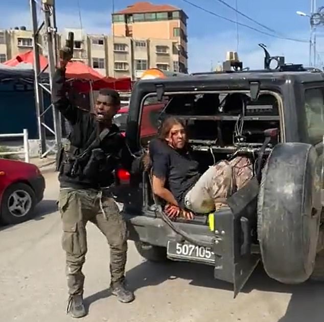 How does it happen that Hamas has defenders?  How does barbarism have a place in our modern age?  A post-holocaust world that vowed 'never again' this weekend saw Jews removed from the safety of their homes and places of business.  (Photo: A hostage is held by Hamas).