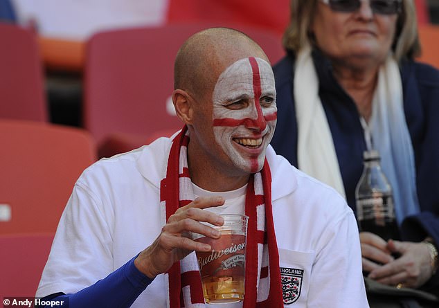 A fan is pictured enjoying a beer as England played Slovenia in the 2010 World Cup