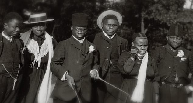 Six members of the Bambuti tribe - from the Congo region of Africa - are seen dressed in western clothing during their stay in Britain, where they performed across the country