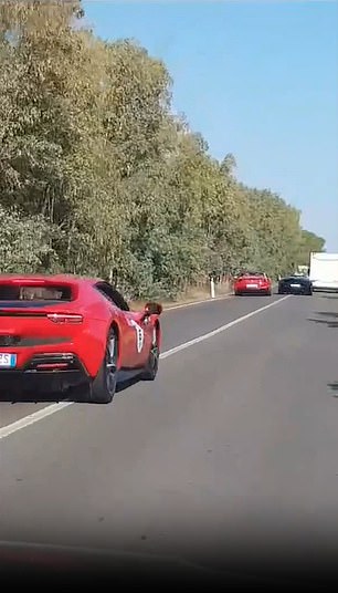 You can see the blue Lamborghini trying to overtake the white camper in front of it, as a line of colorful sports cars drives up the road