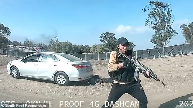 Dashcam captures the moment a gunman unleashes a barrage of bullets from his automatic rifle that sends dust flying around his terrified victim