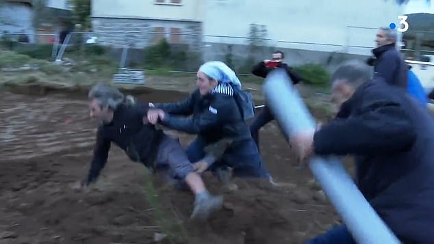 The clip shows the nun sprinting across the muddy construction site of a Catholic center in Saint-Pierre-de-Colombier in the Ardèche and charging towards one of the activists, grabbing him from behind