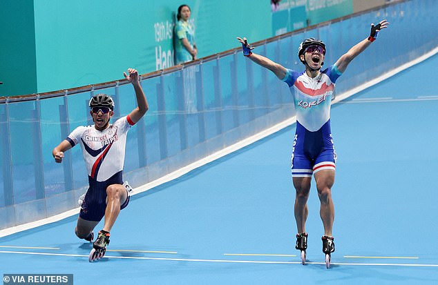 South Korean Jung Cheol-won is tipped to the line by Taiwanese rival Huang Yu-lin during the men's 3000 meter relay final