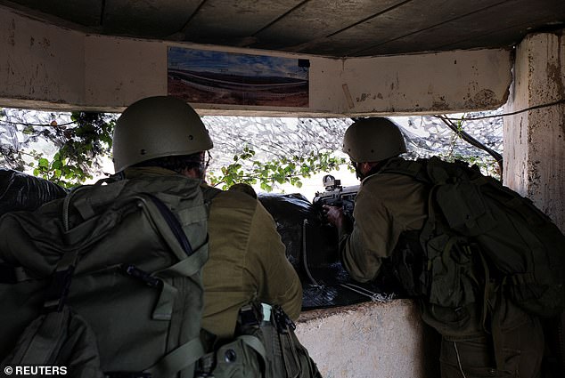 Israeli soldier looks out into Lebanon from the Israeli side of the border as the Jewish state launched a counter-offensive on their northern neighbor