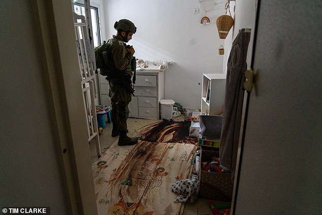 A soldier stands at the site where Itay and Hadar Berdichevsky died trying to save the lives of their ten-month-old twins