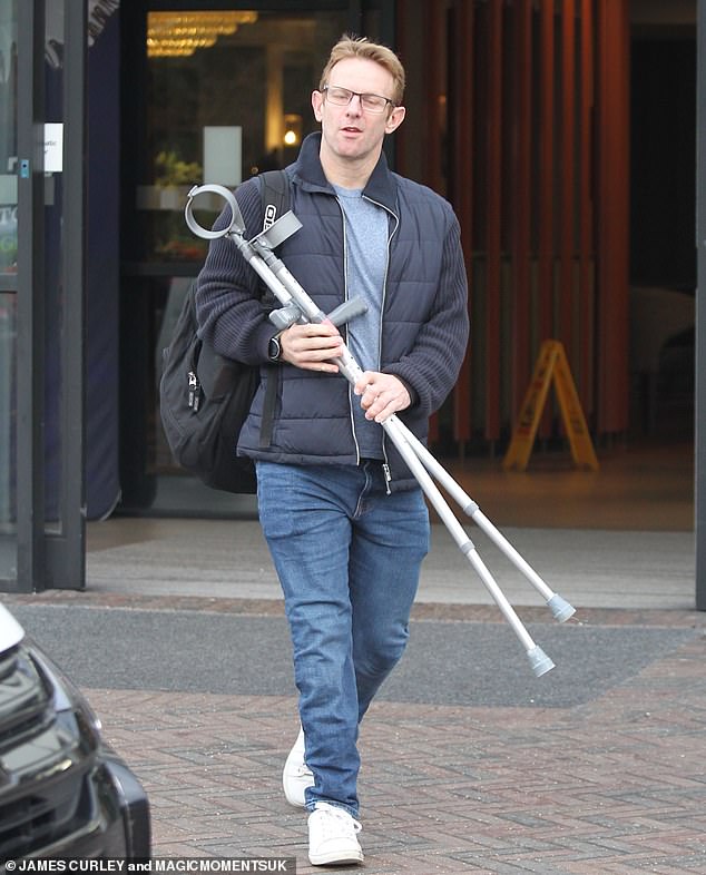 Pained: The star was back on his feet as he headed to dress rehearsals with a smile on his face, but he didn't appear to have fully recovered as he was still carrying his crutches