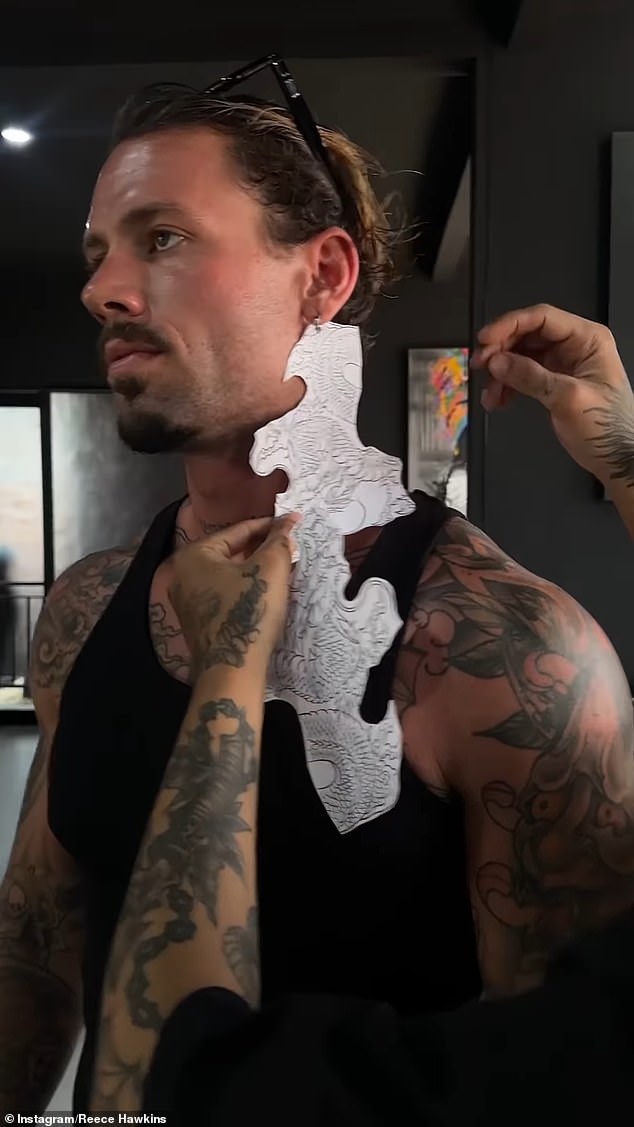 Reece has a focused look in the breathtaking footage as a tattoo artist from Bali works his magic on him by expertly replacing his son's name with a dragon