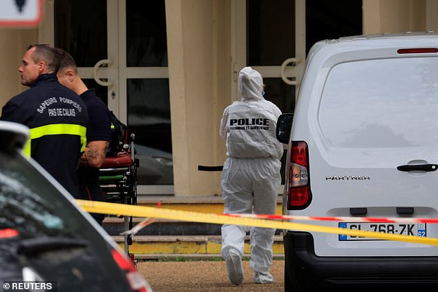 French police and firefighters secure the area after a teacher was killed and several people were injured in a knife attack at Lycee Gambetta-Carnot high school in Arras, northern France.