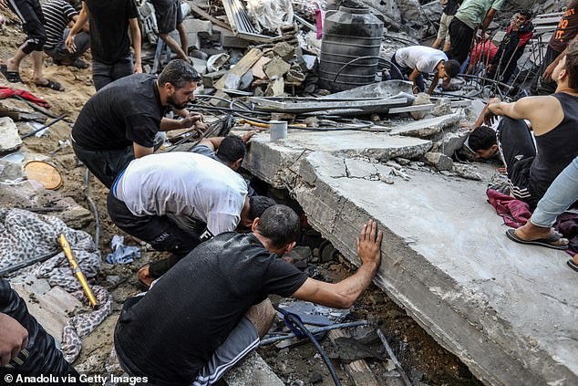 Civil defense teams carry out operations with the help of civilians on the ground after an Israeli airstrike causes destruction in Rafah, Gaza