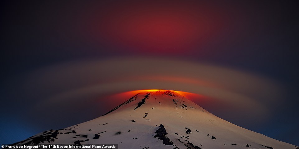 This striking image shows a lenticular cloud over Villarrica, an active volcano in Chile.  The photo, captured by photographer Francisco Negroni, wins the silver medal in the Open Natural Landscapes category