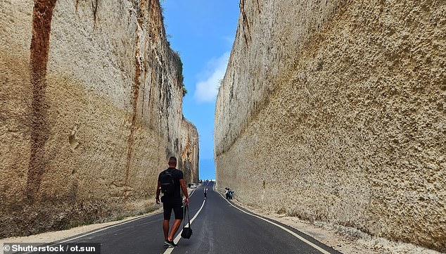 The cliff-lined road leading to Bali's popular Pandawa Beach has sparked a heated online debate, with some social media users criticizing its construction and others describing it as 'incredible'.