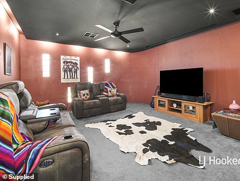 There is also a home theater with striking red walls, movie posters and movie-style seating, as well as a games room and a music room