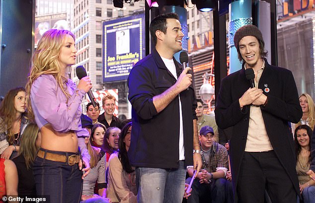 Carson (pictured center with Britney Spears and Brandon Boyd in 2002) was hosting MTV's Total Request Live when he had his first ever panic attack, recalling that it 'came out of nowhere'