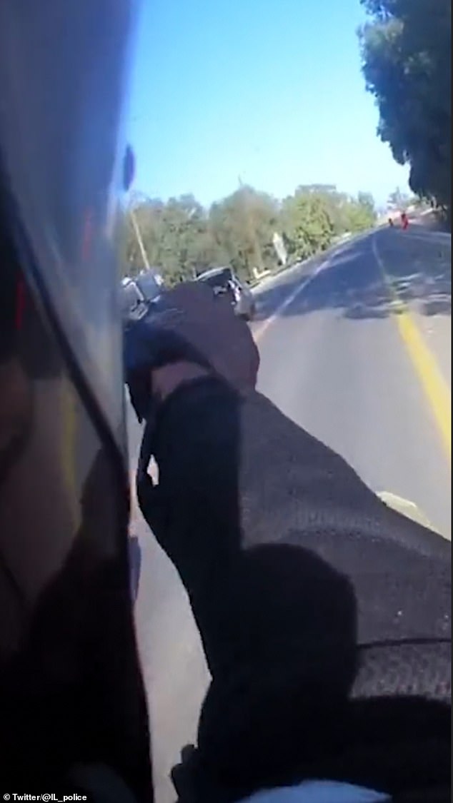 After the officer fires his weapon three times, the car is seen slowing down and turning slightly to the right.