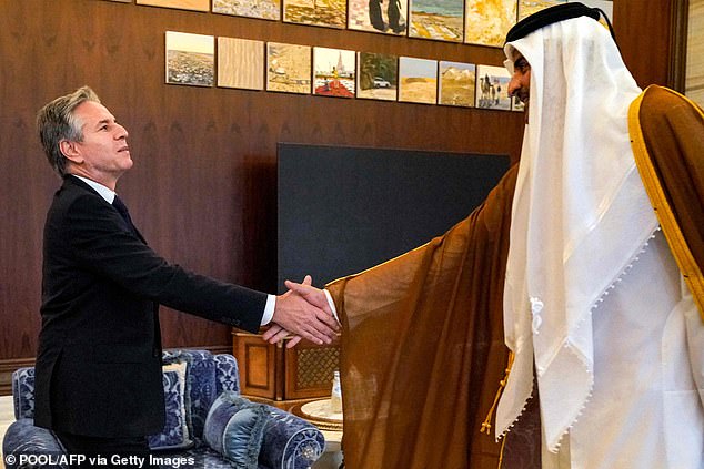 US Secretary of State Antony Blinken (L) shakes hands with Qatar's Emir Sheikh Tamim bin Hamad al-Thani during their meeting in Lusail on October 13, 2023