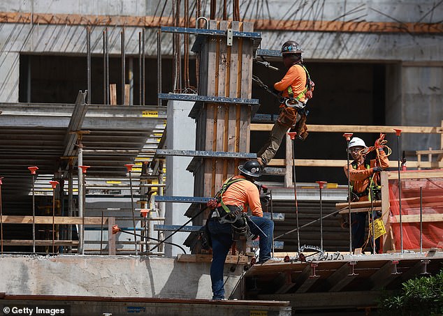 Construction workers are building a residential tower in Miami, Florida.  The US labor market created 336,000 jobs in September