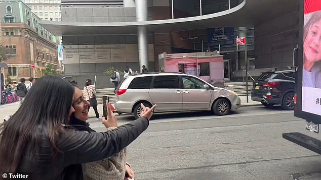 The women were caught on camera on Wednesday laughing at a poster of kidnapped children