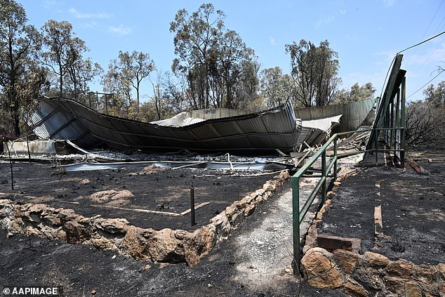 A second person has been killed and 16 homes destroyed by bushfires in the Tara region of Queensland's Western Downs.  The photo shows a destroyed house